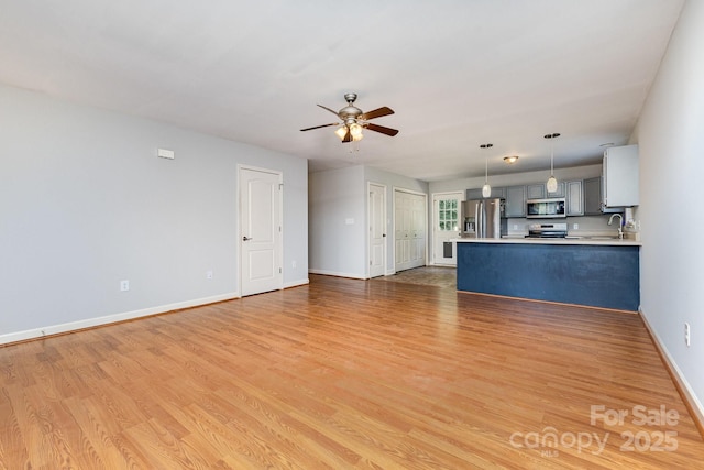 1221 Woodpecker Dr, Clover, SC 29710 - unfurnished living room featuring ceiling fan and light wood finished floors