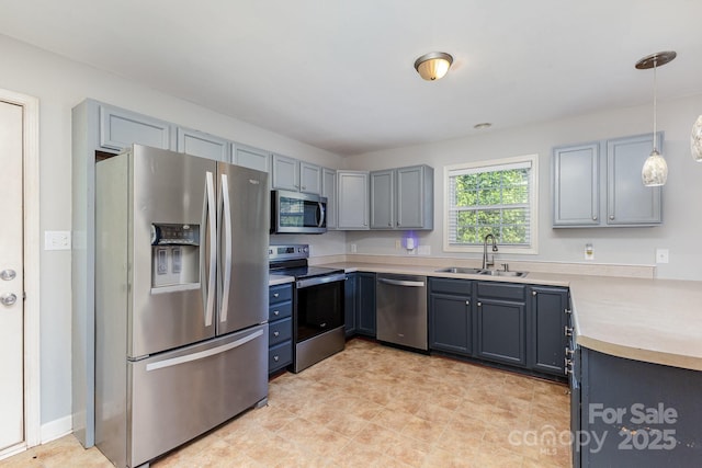 1221 Woodpecker Dr, Clover, SC 29710 - kitchen featuring stainless steel appliances, light countertops, and pendant lighting