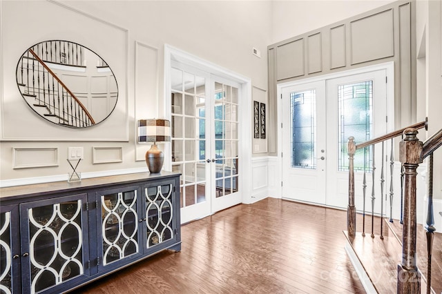 13204 Feale Ct, Charlotte, NC 28278 - foyer entrance featuring french doors, stairway, a decorative wall, wood finished floors, and wainscoting