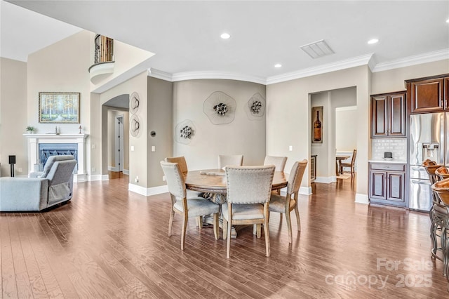 13204 Feale Ct, Charlotte, NC 28278 - dining room featuring ornamental molding, wood finished floors, baseboards, recessed lighting, and a fireplace