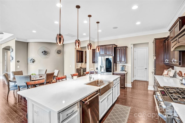 13204 Feale Ct, Charlotte, NC 28278 - kitchen with appliances with stainless steel finishes, a sink, light countertops, dark brown cabinets, and ornamental molding