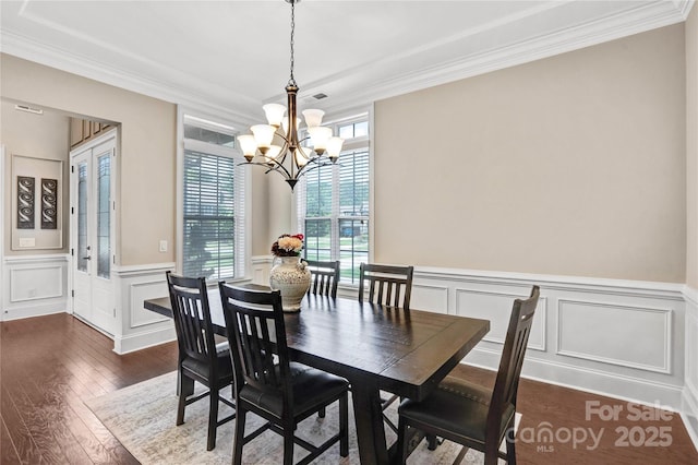 13204 Feale Ct, Charlotte, NC 28278 - dining area featuring a chandelier, a decorative wall, ornamental molding, a wainscoted wall, and dark wood-type flooring