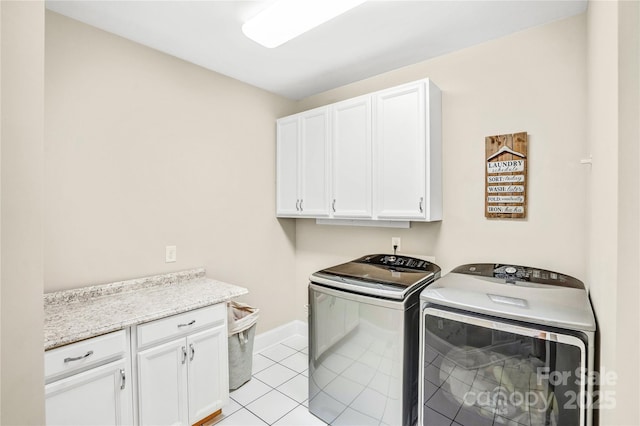 13204 Feale Ct, Charlotte, NC 28278 - washroom featuring independent washer and dryer, cabinet space, baseboards, and light tile patterned floors