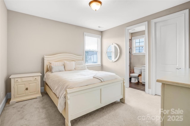 13204 Feale Ct, Charlotte, NC 28278 - bedroom featuring light colored carpet, baseboards, and ensuite bath