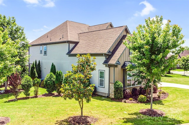 13204 Feale Ct, Charlotte, NC 28278 - view of home's exterior featuring board and batten siding, a lawn, and roof with shingles