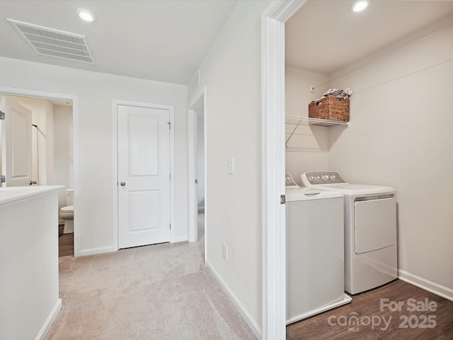 laundry area featuring separate washer and dryer, baseboards, and recessed lighting