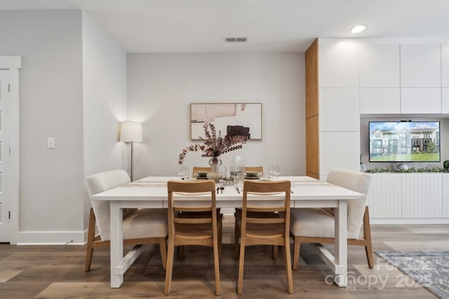 dining space with light wood finished floors, recessed lighting, and baseboards