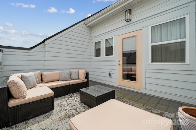 wooden deck with an outdoor hangout area and a patio