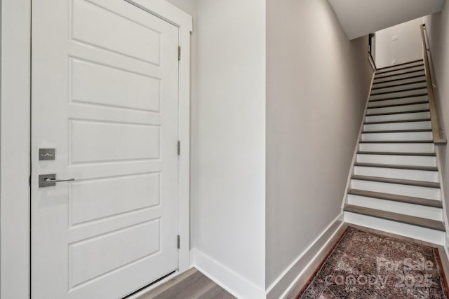 stairs with baseboards and wood finished floors