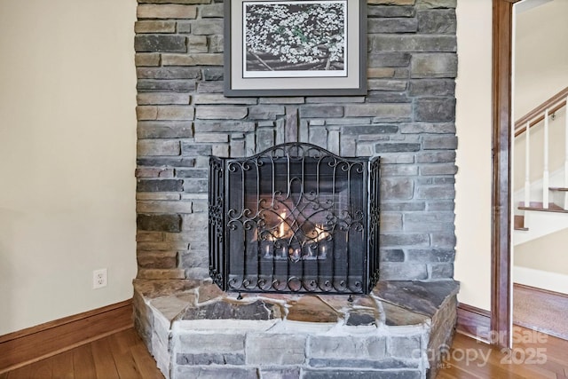2102 Lake Rd, Ridgeway, SC 29130 - detailed view of wood finished floors, baseboards, and a stone fireplace
