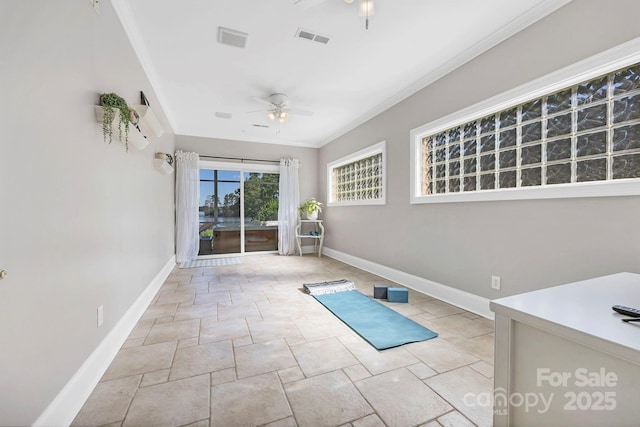 2102 Lake Rd, Ridgeway, SC 29130 - workout area featuring a ceiling fan, baseboards, crown molding, and stone tile flooring