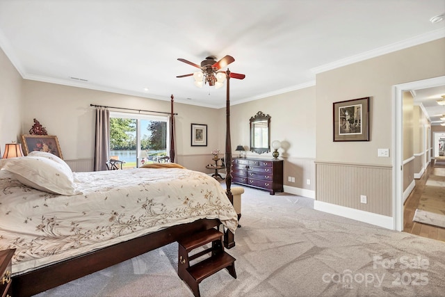 2102 Lake Rd, Ridgeway, SC 29130 - bedroom with ornamental molding, access to outside, a ceiling fan, wainscoting, and light colored carpet