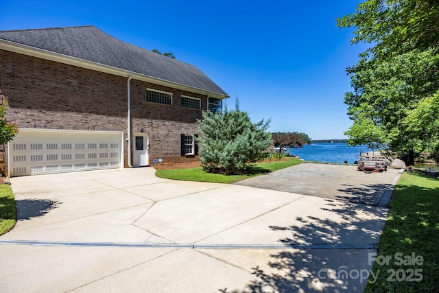 2102 Lake Rd, Ridgeway, SC 29130 - view of home's exterior featuring driveway, brick siding, and a water view