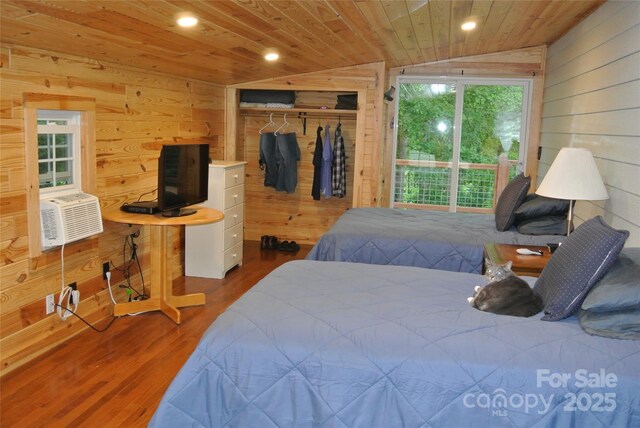 bedroom with wood walls, a closet, wood finished floors, wooden ceiling, and recessed lighting