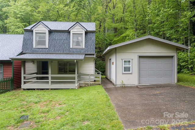 5 Creekside Dr, Maggie Valley, NC 28751 - view of front of property with roof with shingles, covered porch, an outbuilding, and a detached garage