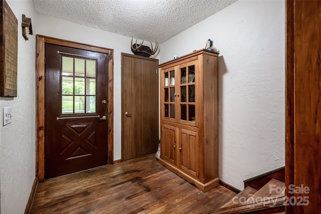 5 Creekside Dr, Maggie Valley, NC 28751 - entryway with a textured ceiling, dark wood finished floors, a textured wall, and baseboards