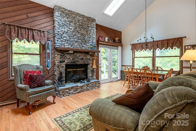 5 Creekside Dr, Maggie Valley, NC 28751 - living area with high vaulted ceiling, hardwood / wood-style flooring, a fireplace, and wooden walls