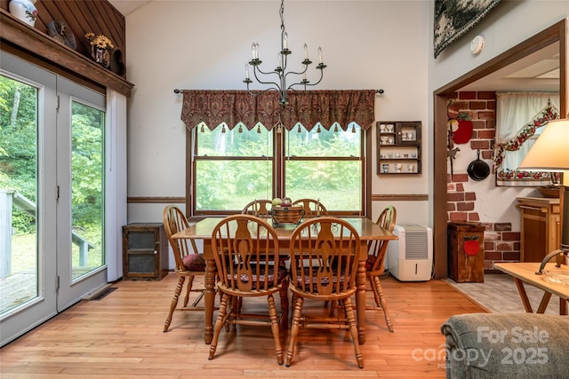 5 Creekside Dr, Maggie Valley, NC 28751 - dining area with a chandelier, light wood-style floors, and plenty of natural light