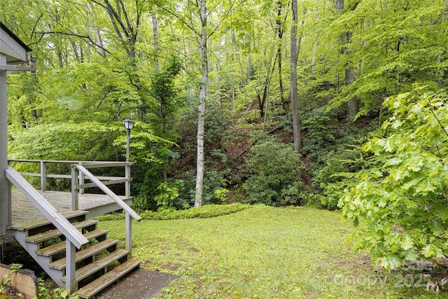 5 Creekside Dr, Maggie Valley, NC 28751 - view of grassy yard featuring stairway, a deck, and a wooded view