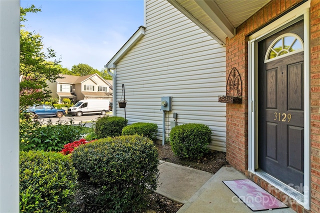 doorway to property featuring brick siding