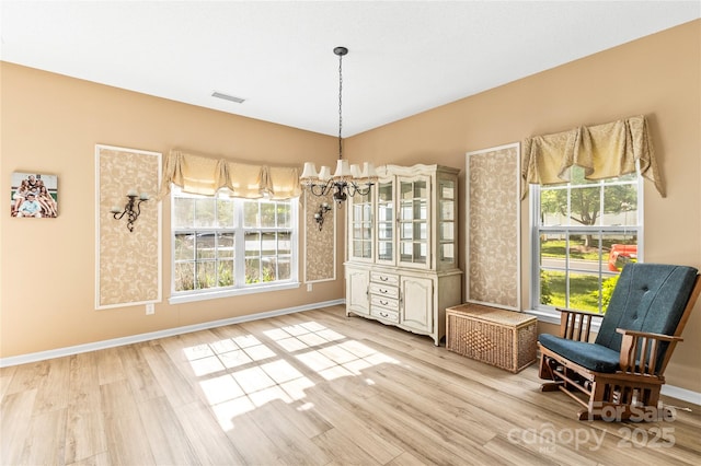 dining room with light wood-type flooring and baseboards