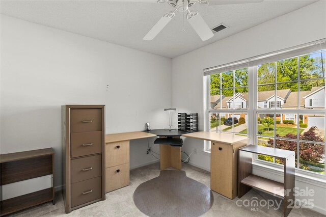 home office featuring ceiling fan, healthy amount of natural light, and baseboards