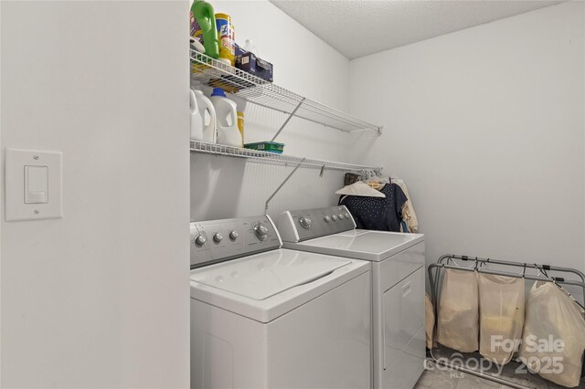 clothes washing area with washing machine and clothes dryer