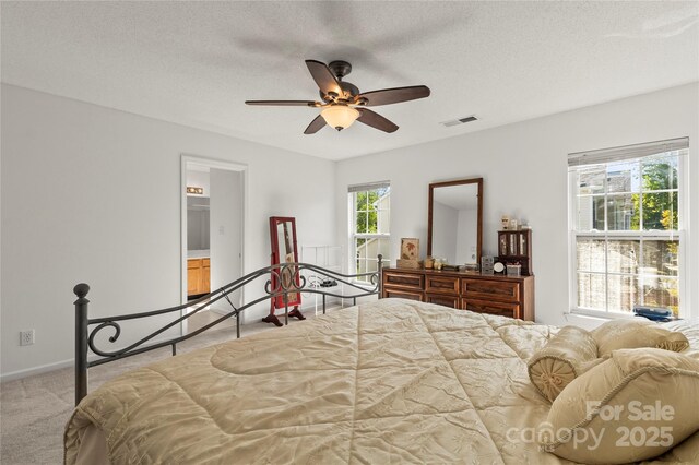 carpeted bedroom with baseboards, a textured ceiling, and a ceiling fan