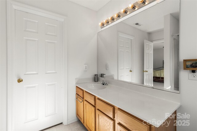 bathroom with vanity and tile patterned floors
