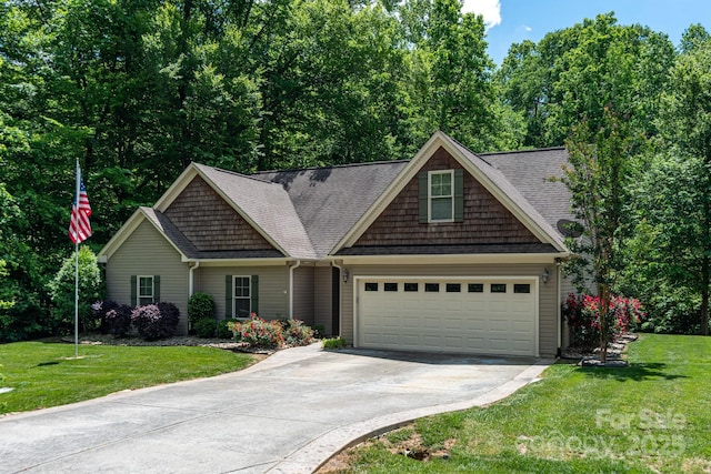 view of front of home with concrete driveway, a front lawn, a garage, and roof with shingles