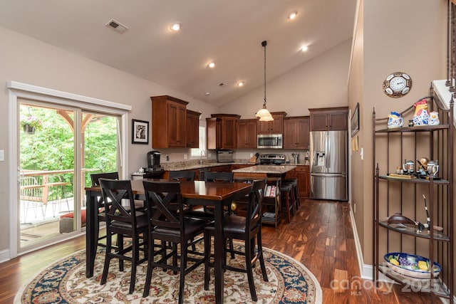 dining area featuring dark wood-type flooring, plenty of natural light, high vaulted ceiling, recessed lighting, and baseboards