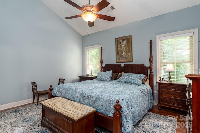bedroom featuring lofted ceiling, wood finished floors, baseboards, and ceiling fan