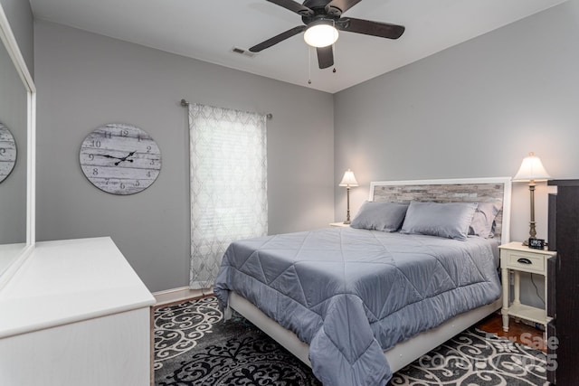 bedroom with wood finished floors, baseboards, and ceiling fan