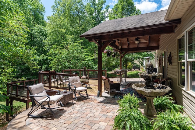 view of patio / terrace with a ceiling fan and a deck