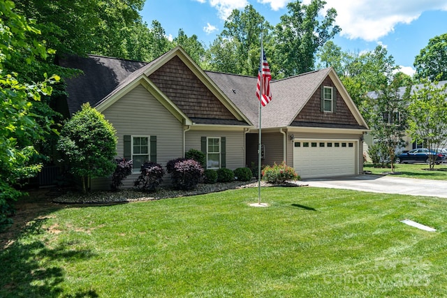 view of front of property with concrete driveway, a shingled roof, and a front lawn
