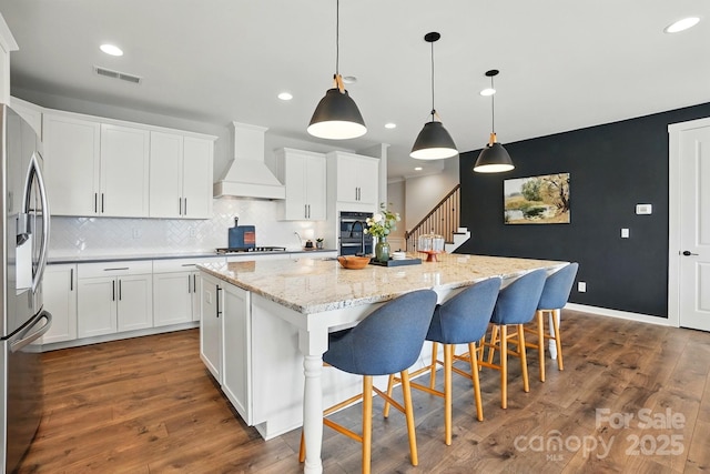 2062 Nellies Way, Fort Mill, SC 29715 - kitchen featuring custom exhaust hood, appliances with stainless steel finishes, a spacious island, recessed lighting, and backsplash