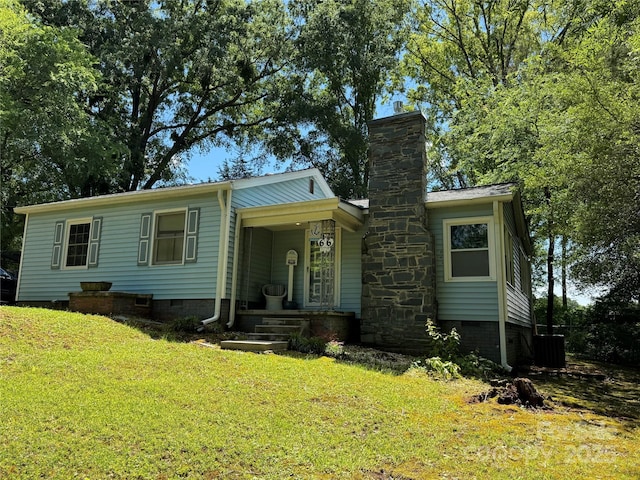 view of front of house with crawl space, a chimney, and a front lawn