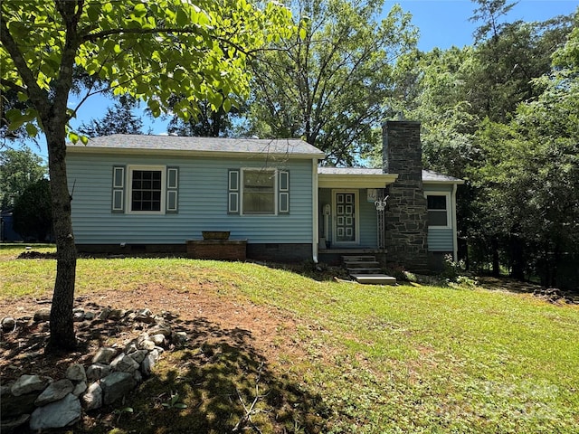 view of front of house featuring crawl space, a front yard, and a chimney