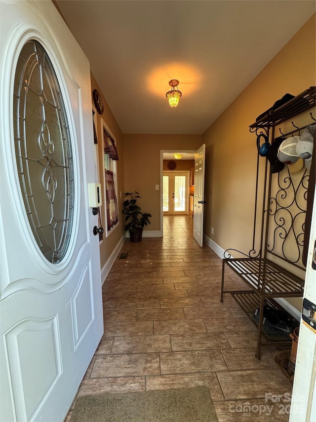 foyer entrance with baseboards and dark wood finished floors