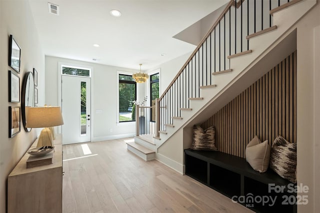 entryway with baseboards, light wood-type flooring, stairway, a chandelier, and recessed lighting