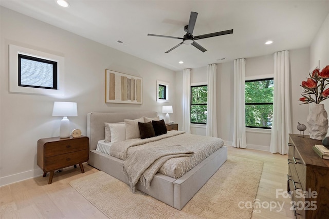 bedroom featuring baseboards, light wood-type flooring, recessed lighting, and a ceiling fan