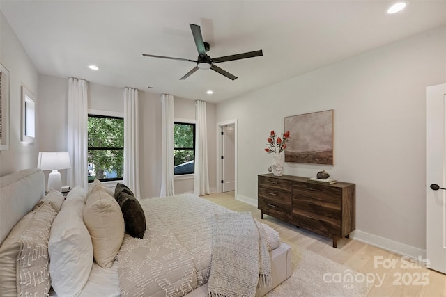 bedroom featuring light wood finished floors, recessed lighting, baseboards, and ceiling fan