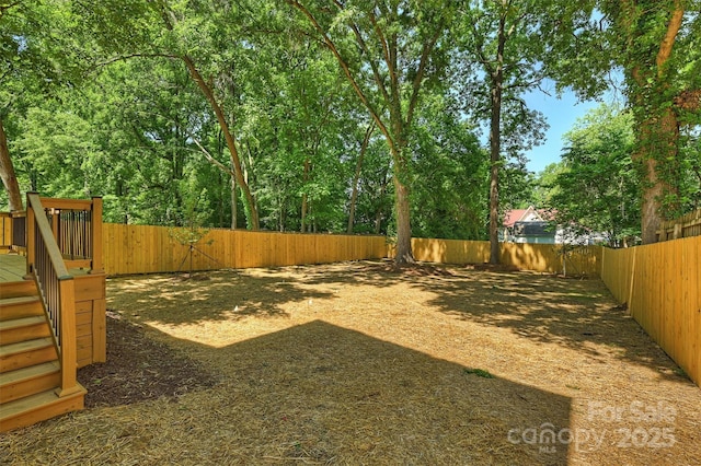 fenced backyard featuring a wooden deck