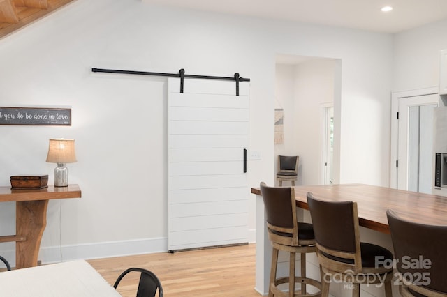 628 Brush Creek Rd, Fairview, NC 28730 - dining room with a barn door, light wood-style flooring, recessed lighting, and baseboards