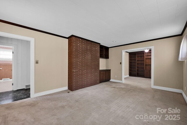 unfurnished living room with light colored carpet, crown molding, baseboards, and built in shelves