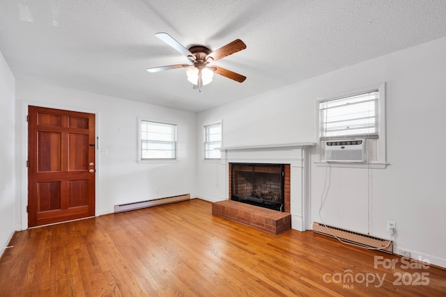 unfurnished living room featuring a baseboard radiator, cooling unit, a brick fireplace, ceiling fan, and a textured ceiling