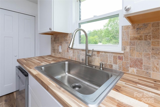 1318 Crawford Rd, Waynesville, NC 28785 - kitchen featuring wood counters, a sink, white cabinetry, dishwasher, and decorative backsplash