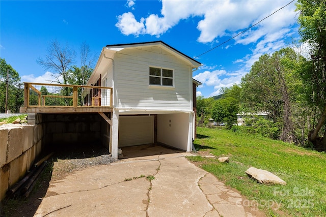 1318 Crawford Rd, Waynesville, NC 28785 - view of side of home with concrete driveway, an attached garage, a wooden deck, and a carport