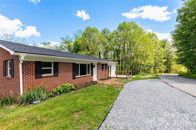 1318 Crawford Rd, Waynesville, NC 28785 - view of front of property featuring brick siding, a front yard, driveway, and roof with shingles