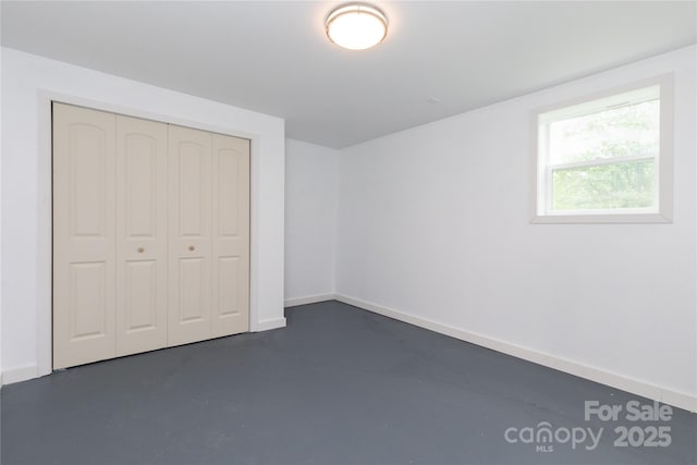 1318 Crawford Rd, Waynesville, NC 28785 - unfurnished bedroom with finished concrete floors, a closet, and baseboards
